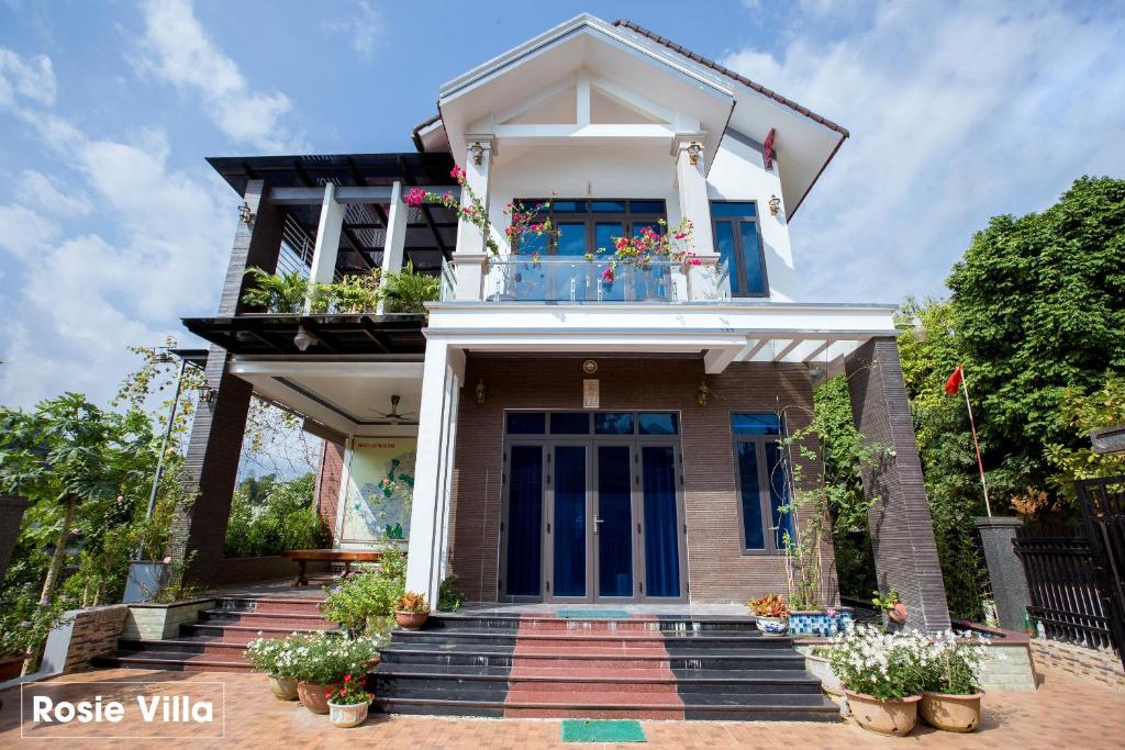 une maison avec un balcon orné de plantes. dans l'établissement Rosie Villa Ha Giang - Motobikerental & Tour, à Ha Giang