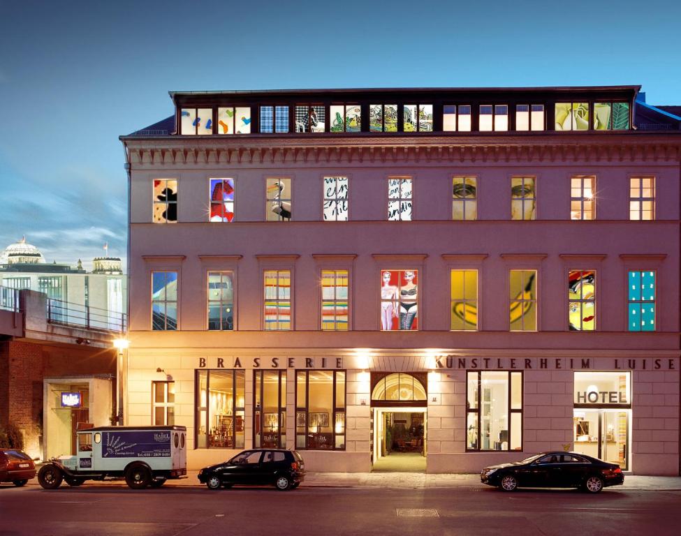 a large building with cars parked in front of it at Arte Luise Kunsthotel in Berlin