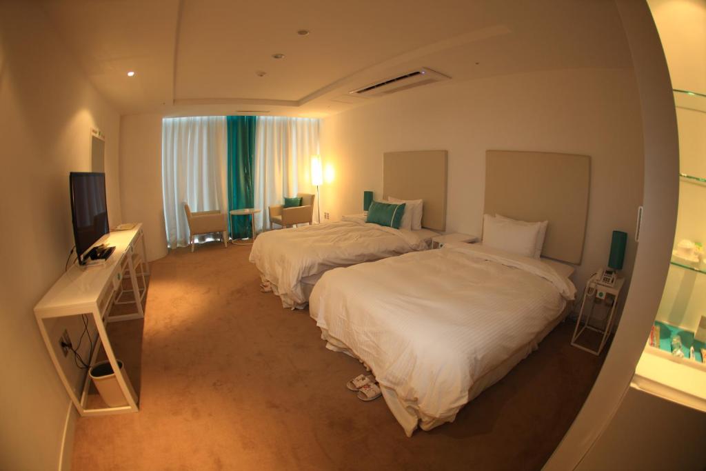 Postel nebo postele na pokoji v ubytování Ecograd Hotel