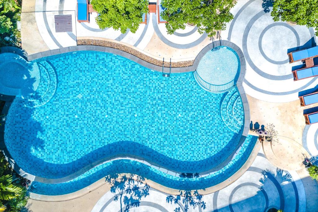 an overhead view of a large swimming pool at The Tama Hotel- SHA Plus in Ao Nam Mao