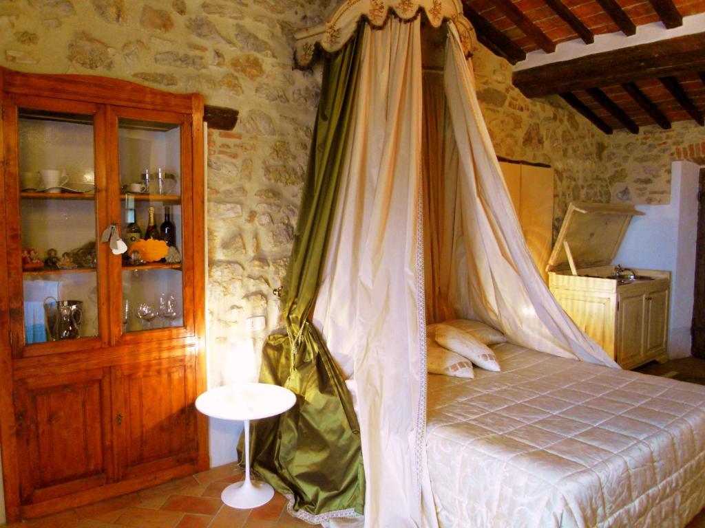 a bedroom with a bed with a canopy at Guest House il Borgo di Sempronio in Semproniano