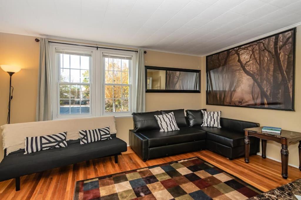 a living room with a couch and a table at 915CountyLineRoad Luxury Mainline Train Colleges in Bryn Mawr