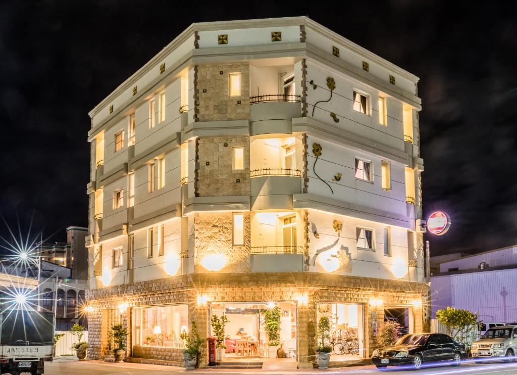 a tall white building with lights on it at 湯園民宿 l 民宿編號1639 in Taitung City