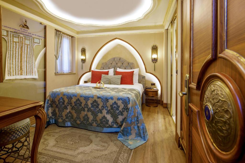 a bedroom with a bed with an arched headboard at Romance Istanbul Hotel Boutique Class in Istanbul