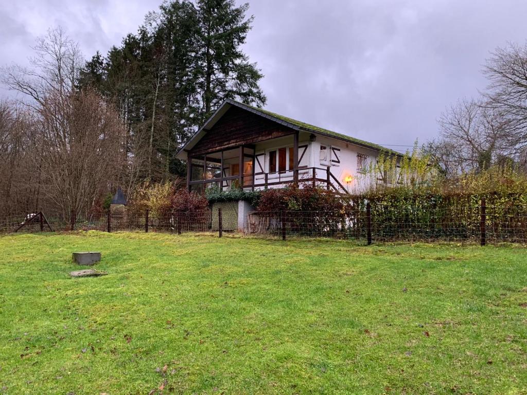 ein Haus mit einem Zaun im Hof in der Unterkunft Étoile de Laforêt in Laforêt