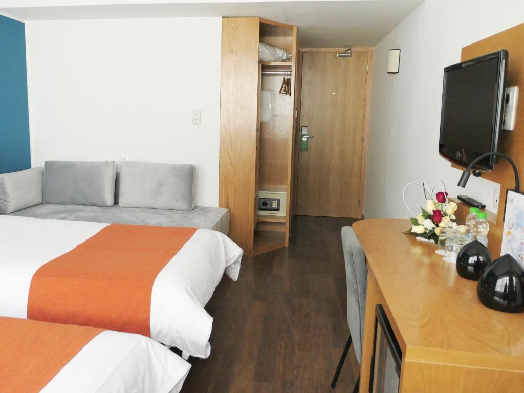 TV a/nebo společenská místnost v ubytování Le Pietri Urban Hotel