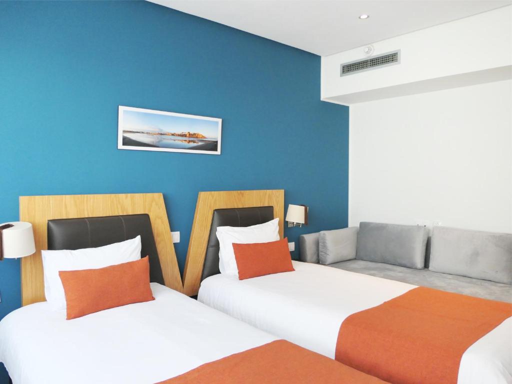 Postel nebo postele na pokoji v ubytování Le Pietri Urban Hotel