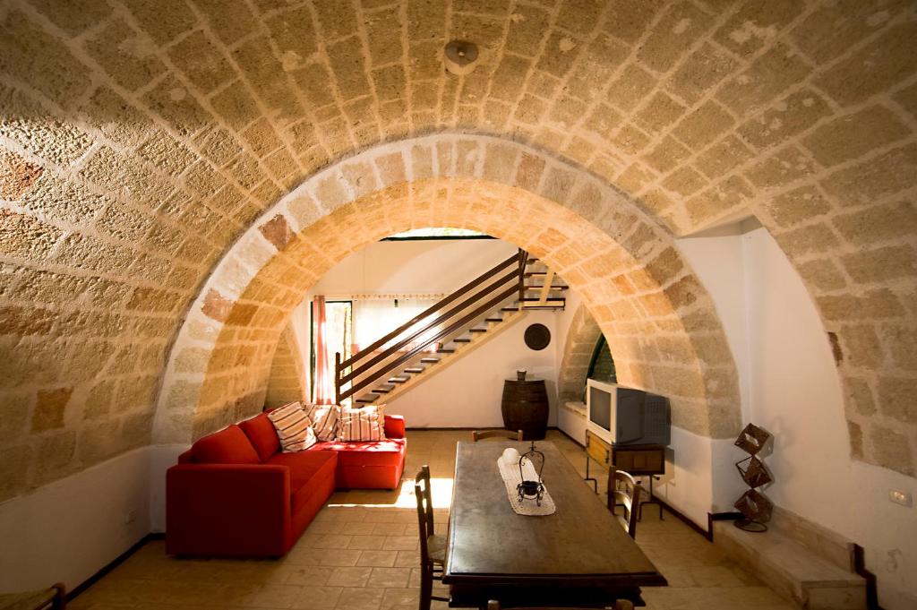 a living room with a couch and a table at Masseria Spina Resort in Monopoli