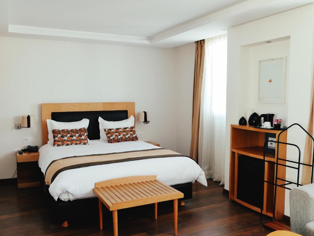 Postel nebo postele na pokoji v ubytování Le Pietri Urban Hotel