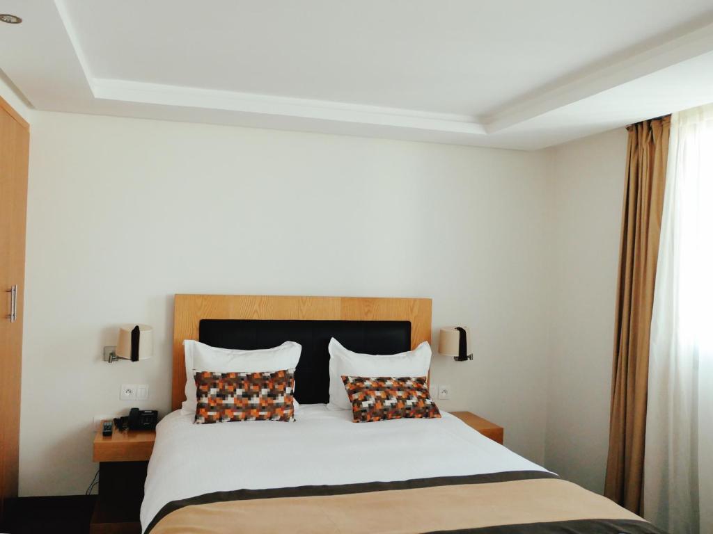 Postel nebo postele na pokoji v ubytování Le Pietri Urban Hotel