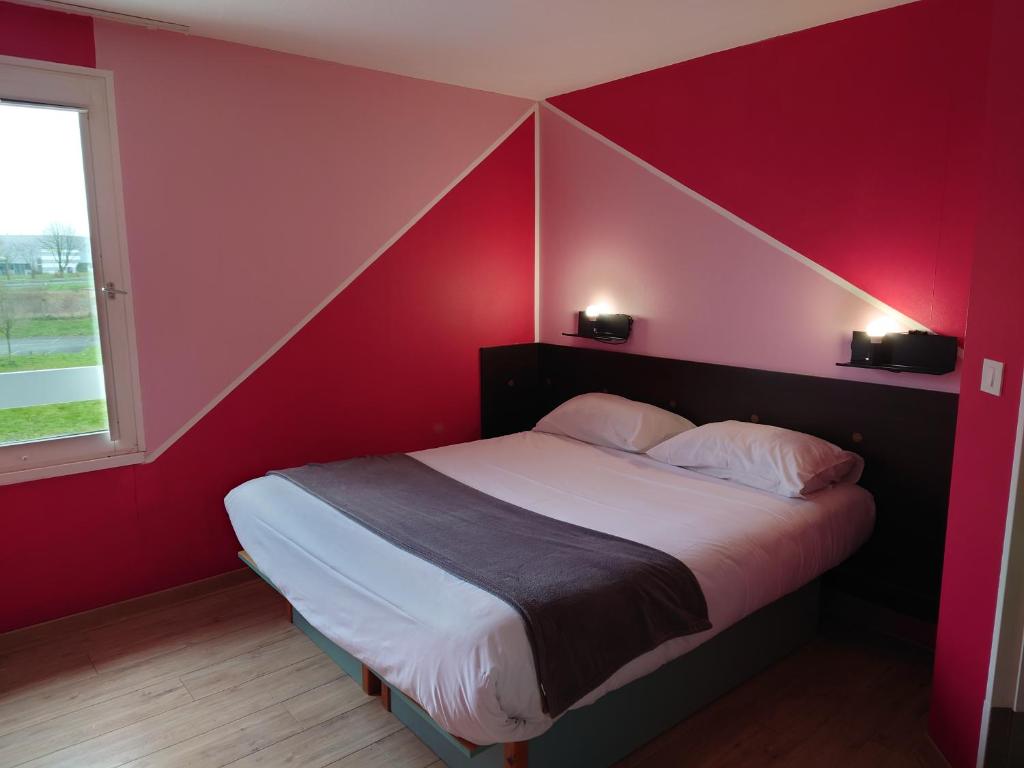 a red room with a bed in a room at Fasthotel Angers Beaucouzé in Beaucouzé
