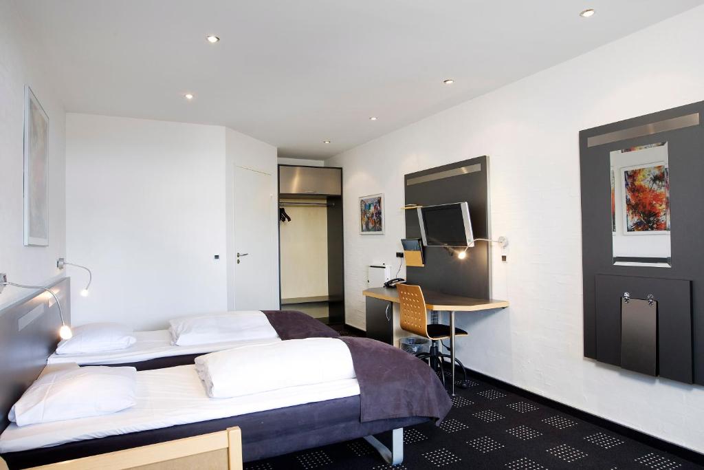 Postel nebo postele na pokoji v ubytování Hotel Hedegaarden