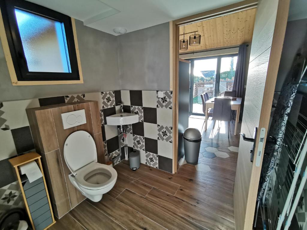 a small bathroom with a toilet and a table at Le Petit Renard in Saint-Jouin-Bruneval