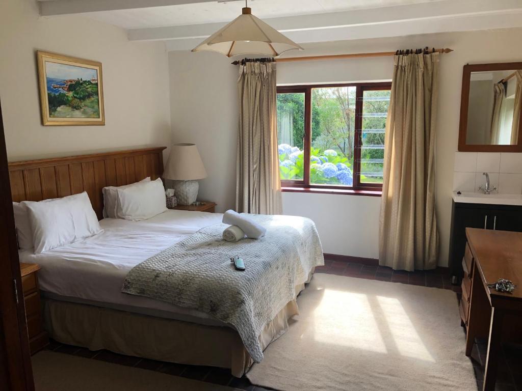 a bedroom with a bed and a window at The Volmoed Trust in Hermanus