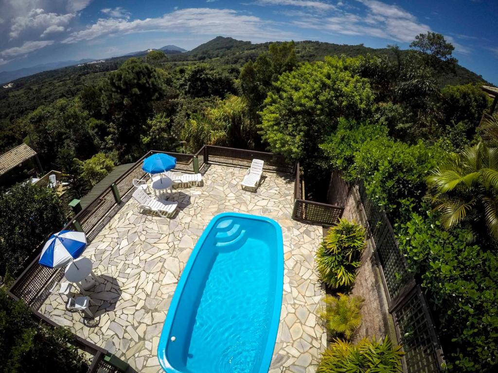 an overhead view of a swimming pool with umbrellas at Pousada Vale Verde Bungalows in Praia do Rosa