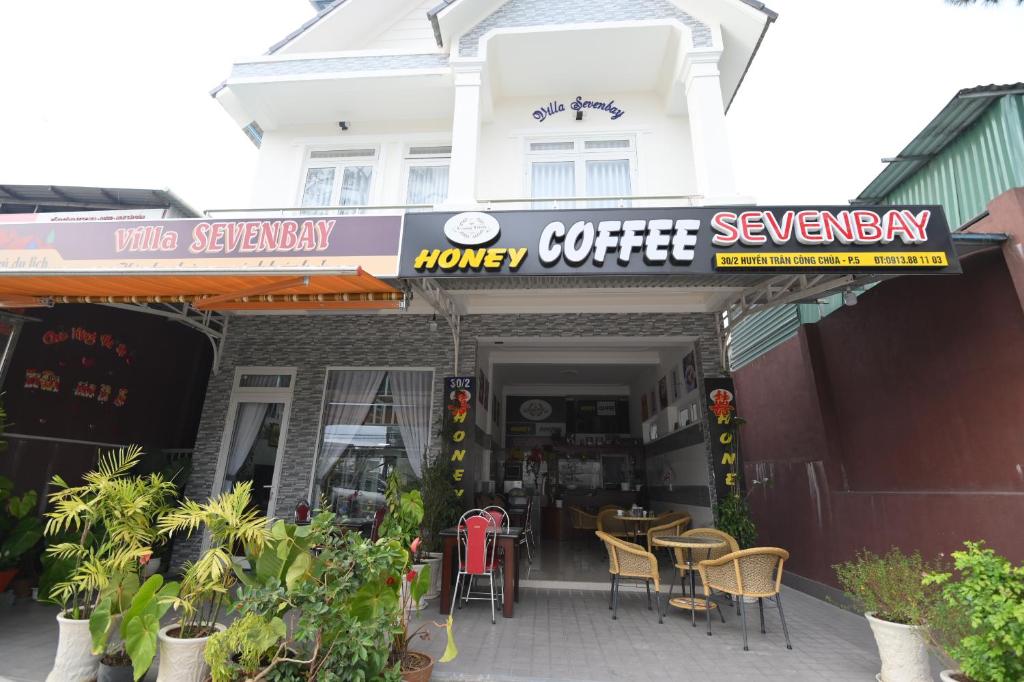 a coffee shop with tables and chairs in front of it at Villa SEVENBAY in Da Lat