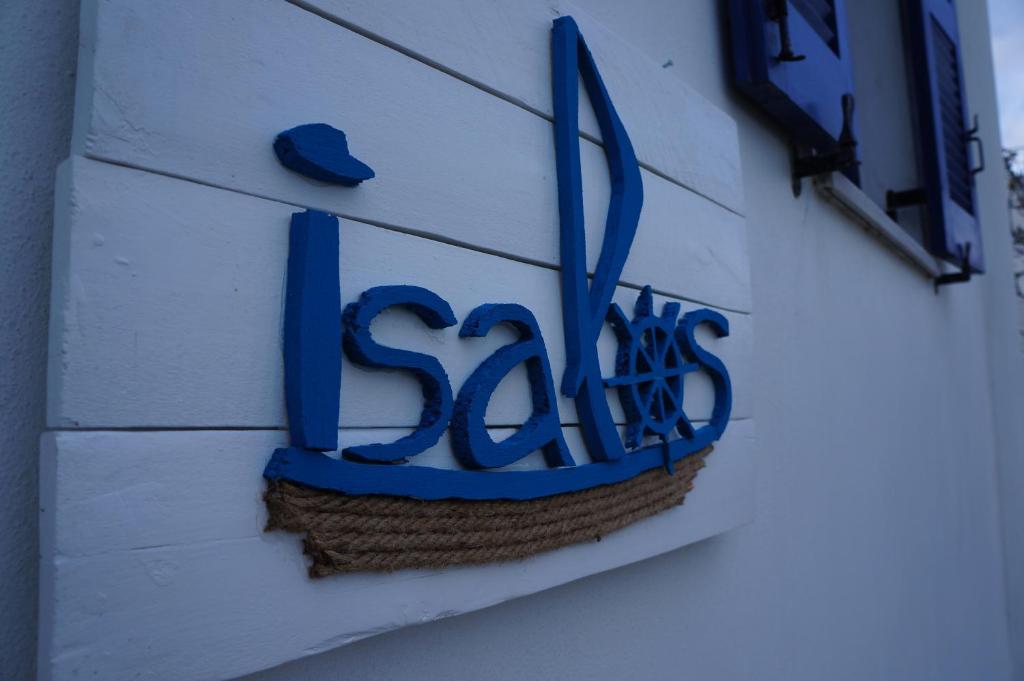 a sign on the side of a building at Isalos Paros in Naousa