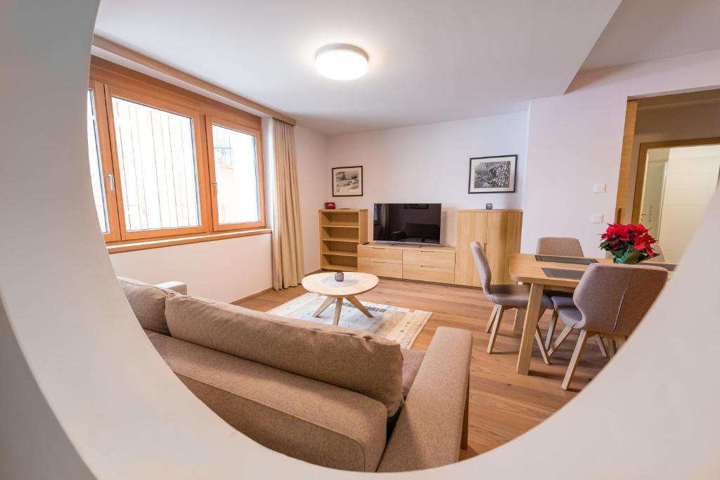 a living room with a couch and a table at Apartments Bergleben Goldegg in Goldegg