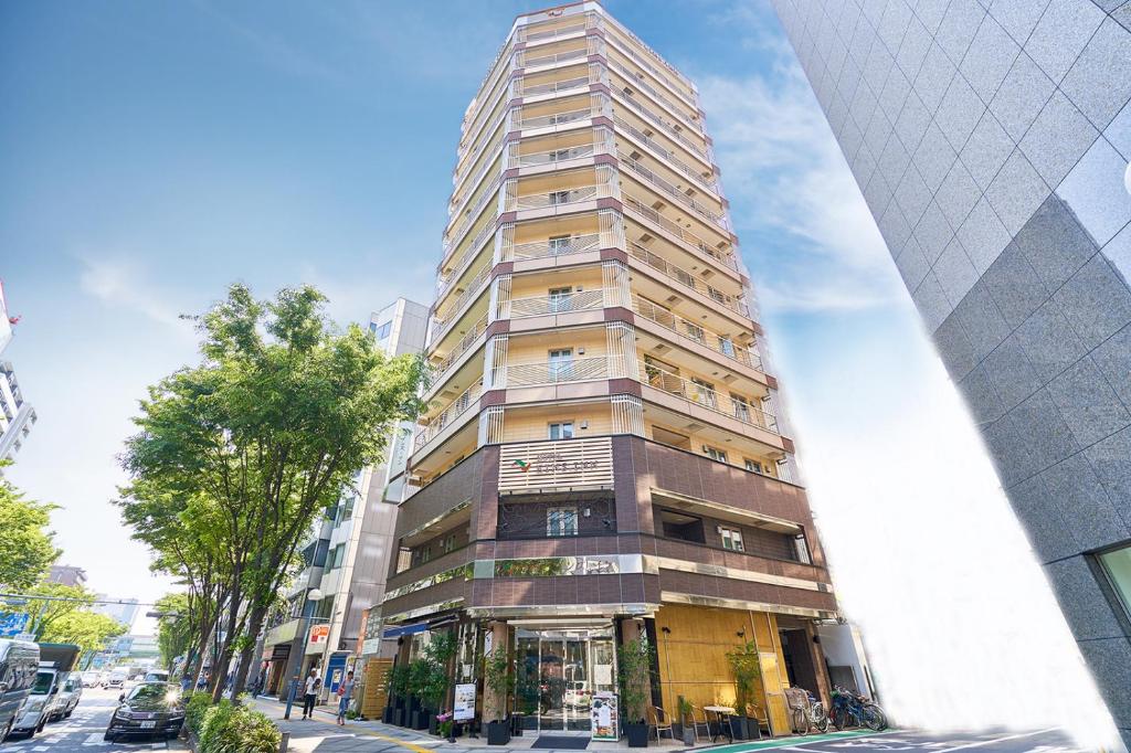 a tall building on the side of a street at Eins.Inn Umeda Higashi in Osaka