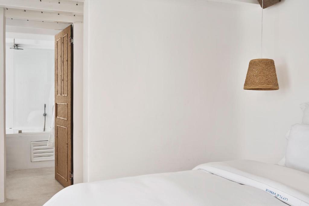 A bed or beds in a room at Little Venice Suites