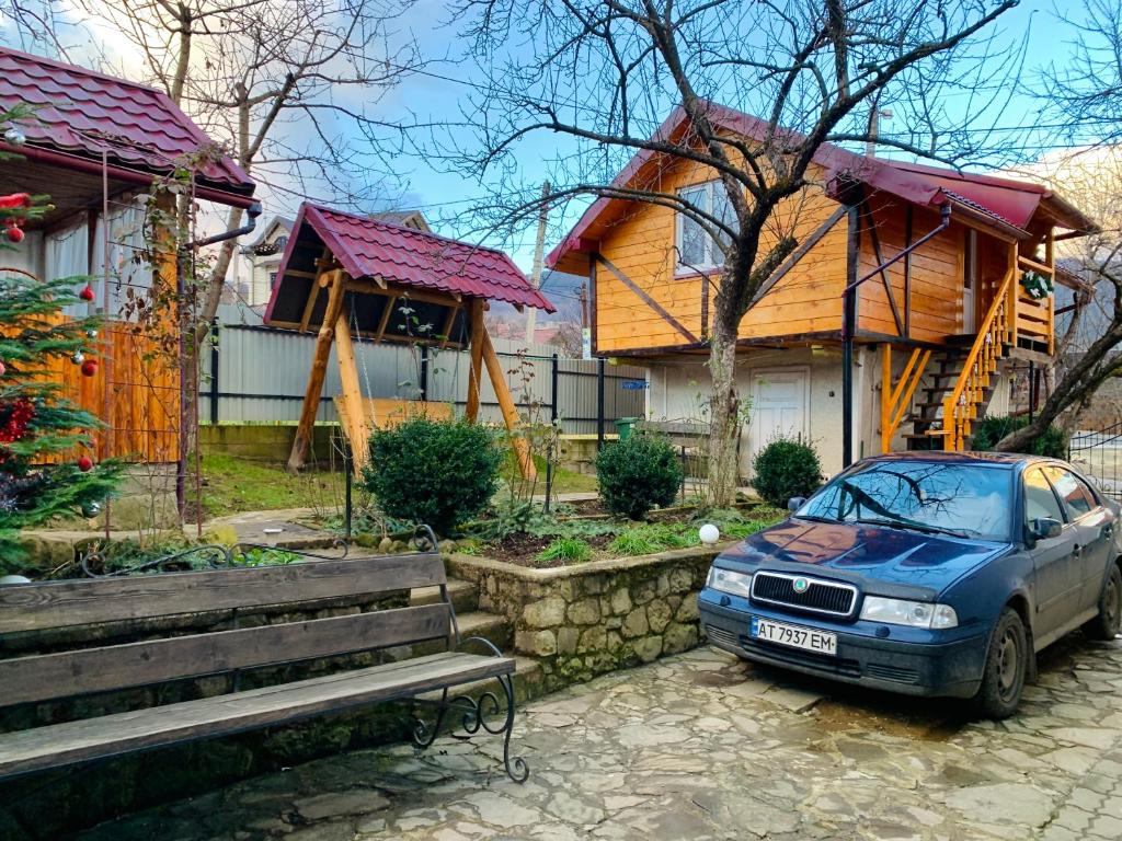 a car parked in front of a house at За горбами in Yaremche