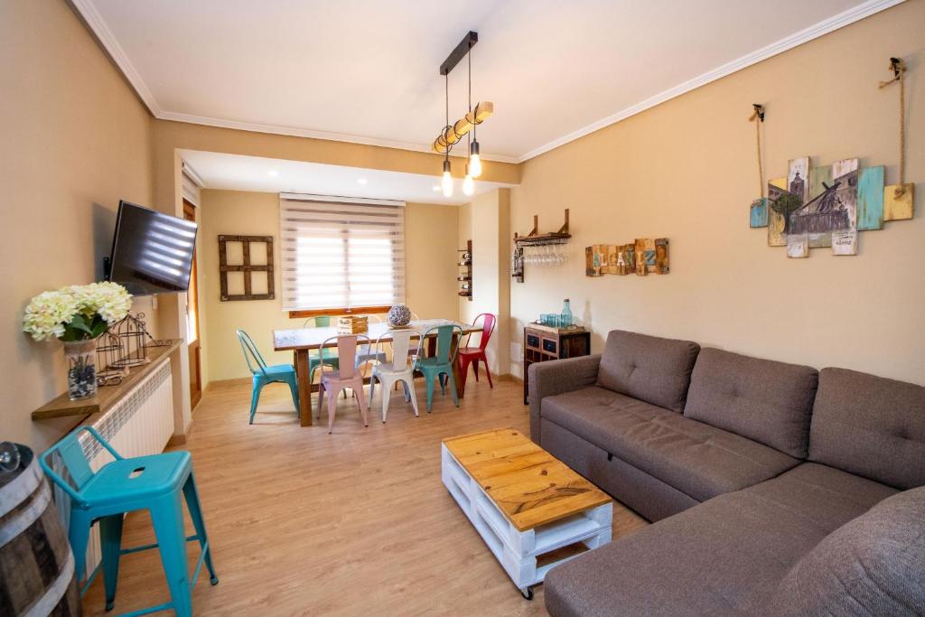 a living room with a couch and a table at MEQUEDO CASA PILARCHO in Alcañiz