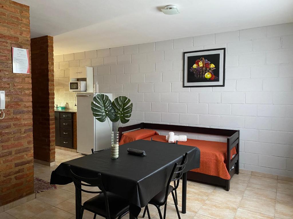 Habitación con cama y mesa con sillas. en Casa Nuova Depto CUATRO en Villa María