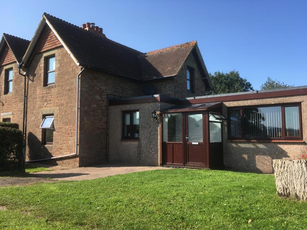 an extension to a house with a garage at Forest of Dean Country Cottage in Mitcheldean