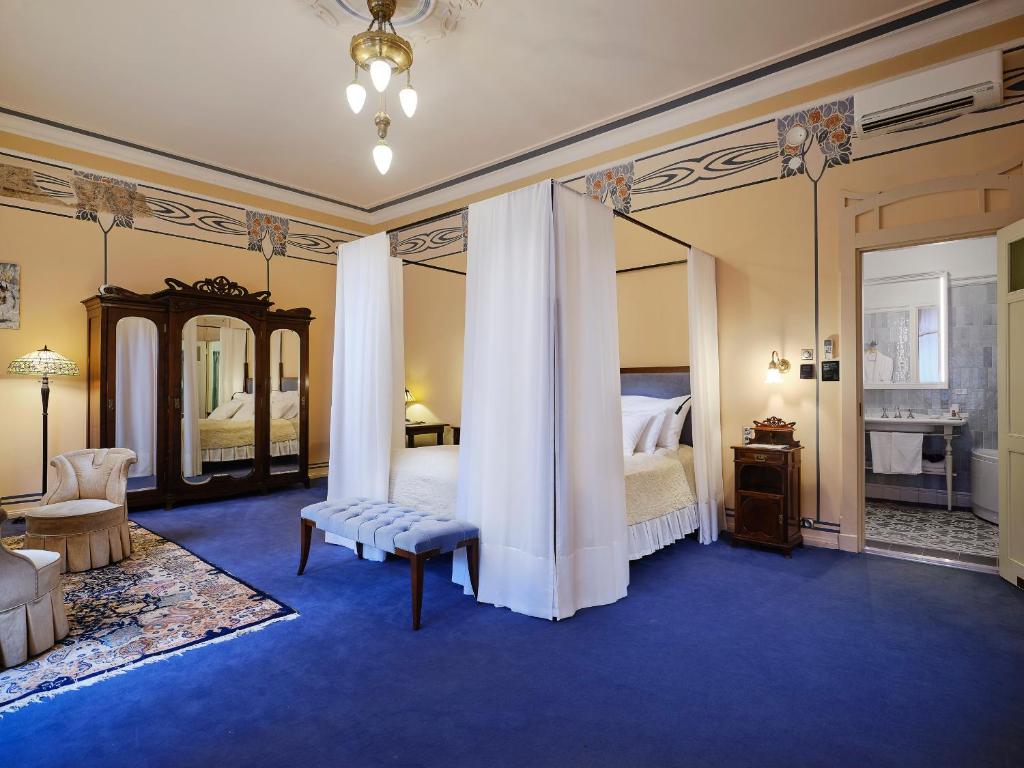 a large room with a bed and a mirror at Villa Ammende Restaurant and Hotel in Pärnu