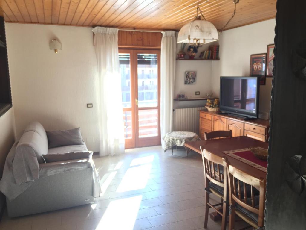 a living room with a couch and a table and a tv at residenza in zona Pontedilegno T02034 in Villa Dalegno