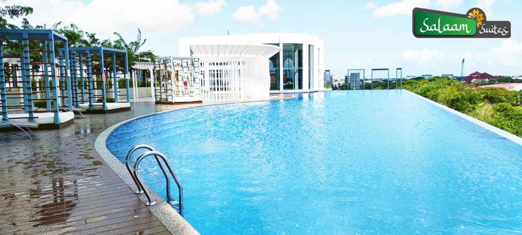 a swimming pool at a resort with a building at Troika Kota Bharu by Salaam Suites in Kota Bharu