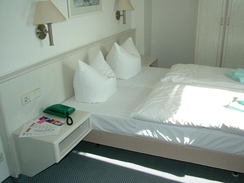 Postel nebo postele na pokoji v ubytování Hotel Fabrice