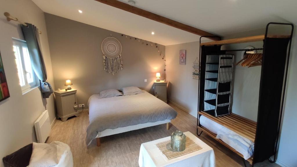 a small bedroom with a bed and a shelf at Domaine de l'Hôtel au Franc in Fleury
