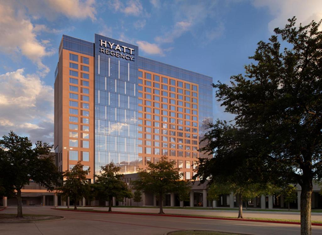 a tall building with a sign on top of it at Hyatt Regency Frisco-Dallas in Frisco