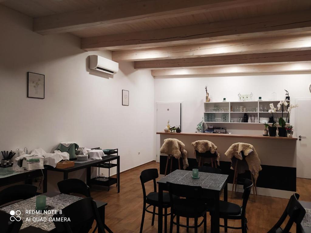 een eetkamer met tafels en stoelen en een keuken bij Villa Liduška s kavárnou in Bechyně