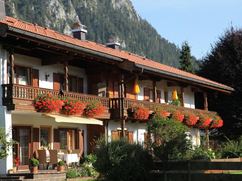 a building with flower boxes on the front of it at Gästehaus Gschwendtner - Chiemgau Karte in Inzell