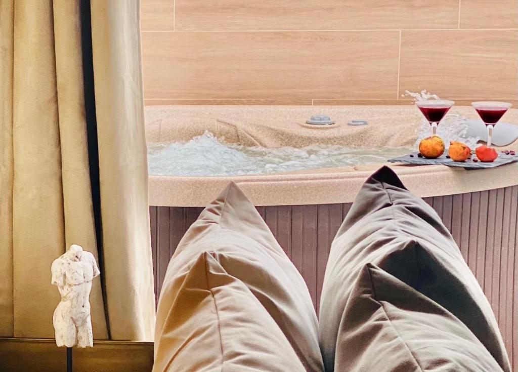 a person laying in front of a bath tub with a hot tub at Canaryislandshost l The Secret Suites in Playa Honda