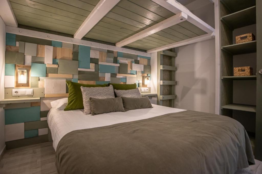 a bedroom with a large bed with a colorful wall at MONTAÑAS in Sierra Nevada