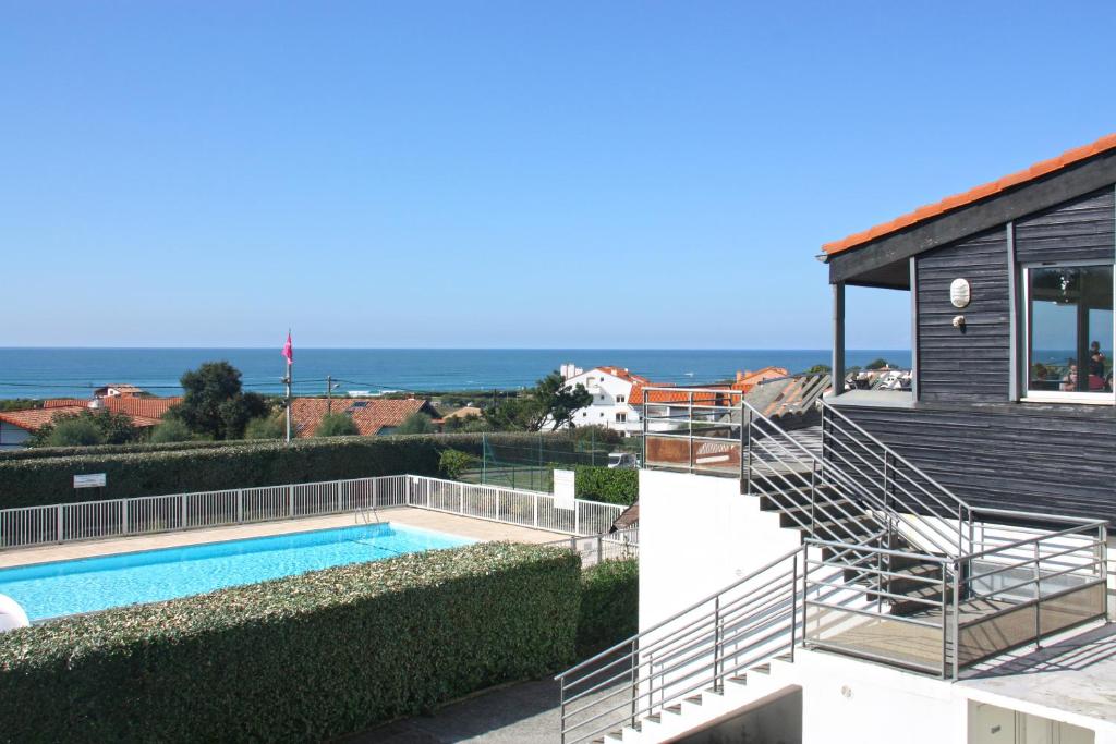 a house with a swimming pool and a staircase at Village Vacances Azureva Anglet in Anglet