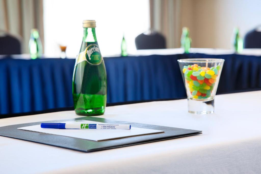 a bottle of champagne and a glass of candyballs at Holiday Inn Express & Suites Ottawa West - Nepean by IHG in Ottawa