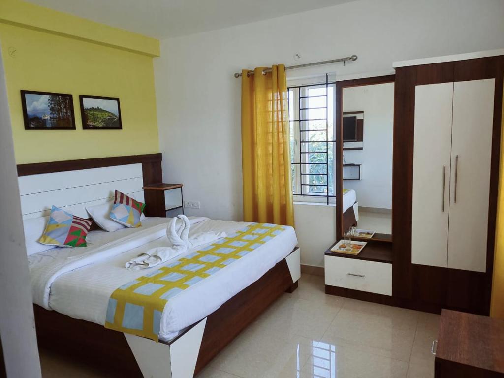 een slaapkamer met een groot bed en een raam bij Brown Tree Resorts in Ooty