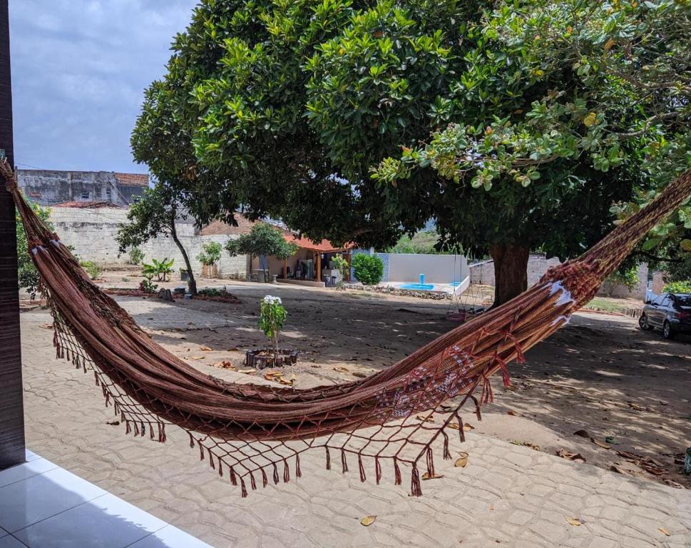 a hammock sitting in front of a tree at Pousada Viana in Garanhuns