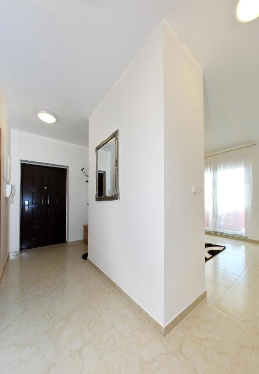a large white room with a mirror on a wall at Apartment Village Nin in Nin