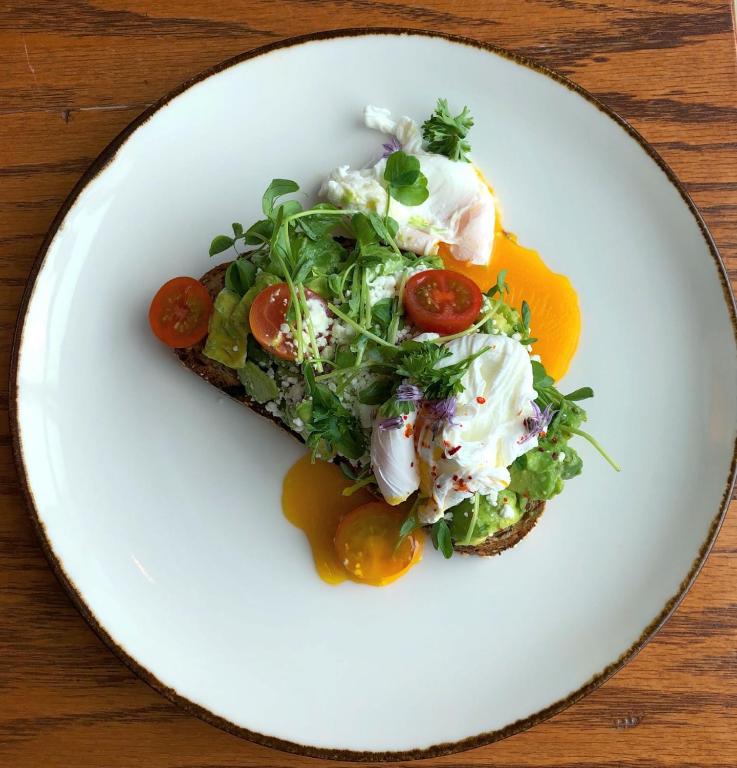 a white plate with a salad with eggs and tomatoes at InterContinental Boston by IHG in Boston