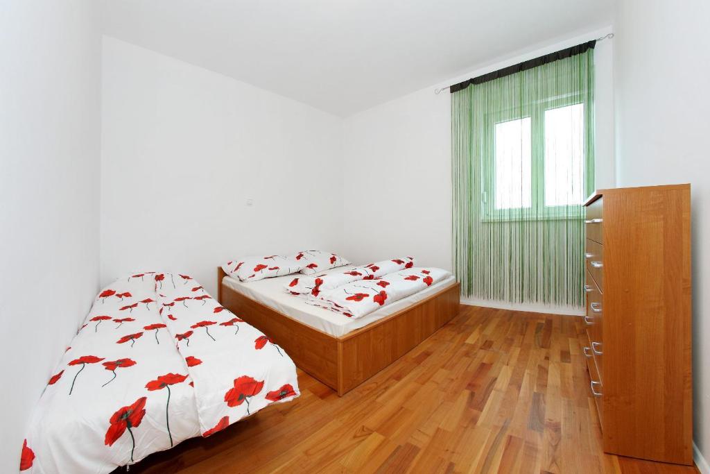 a bedroom with two twin beds and a dresser at Apartment Village Nin in Nin