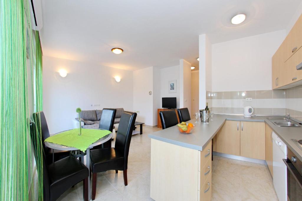 a kitchen and dining room with a table and chairs at Apartment Village Nin in Nin