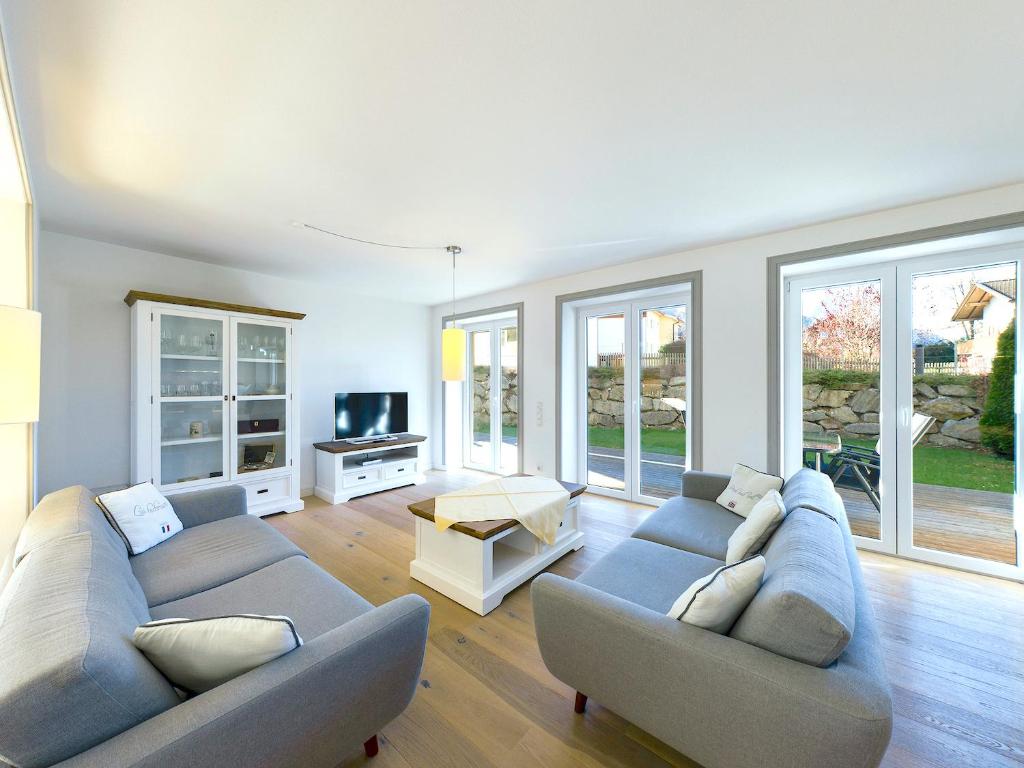 a living room with two couches and a tv at GardenLodge in Garmisch-Partenkirchen