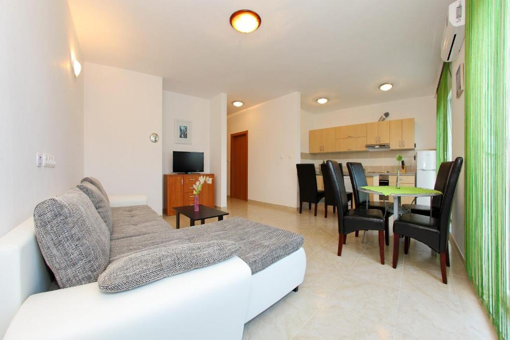 a living room with a couch and a table at Apartment Village Nin in Nin
