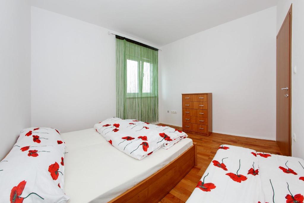 a bedroom with two beds and a window at Apartment Village Nin in Nin