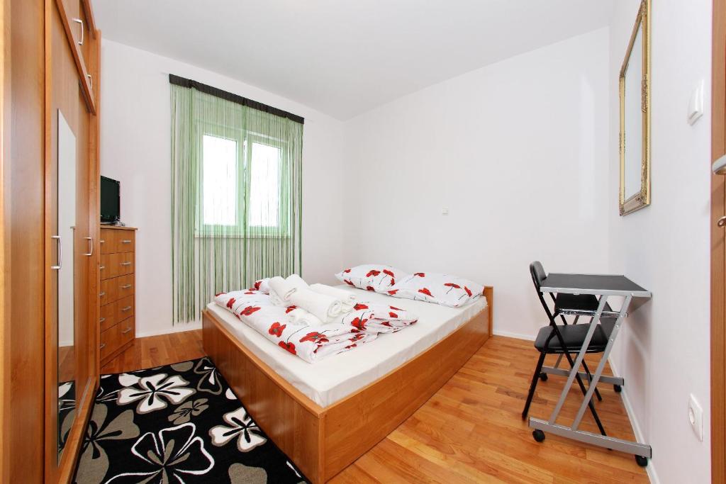 a bedroom with a bed and a chair in it at Apartment Village Nin in Nin